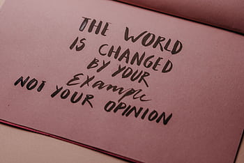 Motivational phrase emphasizing actions over words displayed on textured paper. HD wallpaper