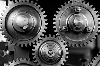 Detailed black and white of interlocking metal gears showcasing industrial mechanics. HD wallpaper