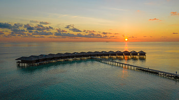 Sunset, huts, resort, islands, sea HD wallpaper