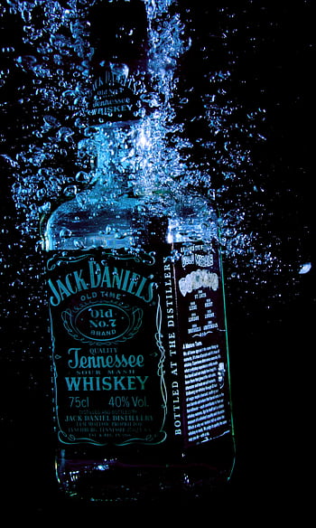 Jack Daniel's whiskey bottle submerged in water with bubbles, creating a dramatic effect. HD phone wallpaper