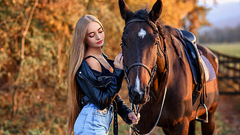 Girl Model Is Standing Near Brown Horse Wearing Blue Jeans Black Jerkin In Blur Background Girls HD wallpaper