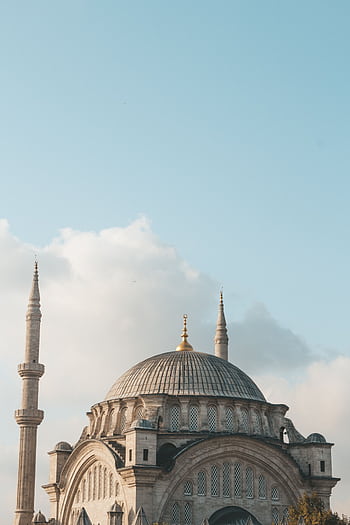 A scenic view of a historic mosque with tall minarets under a clear blue sky in Istanbul. HD phone wallpaper