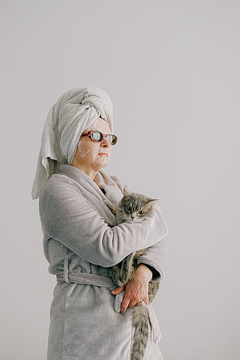 Woman in a bathrobe with a cat, representing relaxation and home spa vibes. HD phone wallpaper