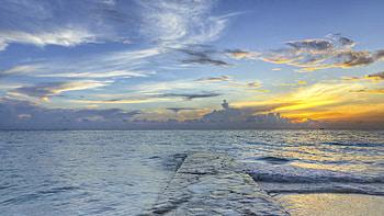 stone wharf under beautiful sea sunset, sea, wharf, clouds, sunset, stones HD wallpaper