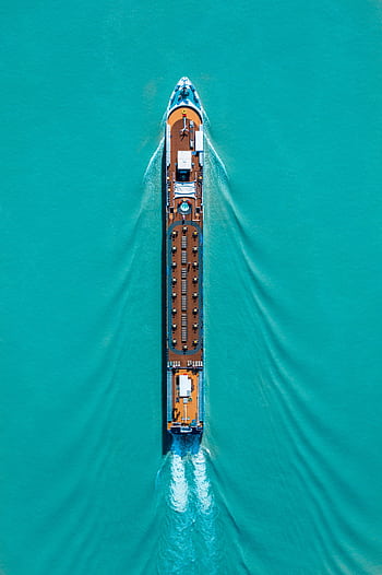 Drone shot of a cruise ship navigating turquoise waters, creating ripples and waves. HD phone wallpaper