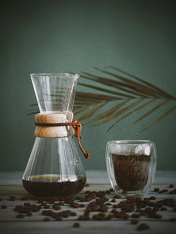 A minimalist coffee setup featuring a Chemex and glass with roasted coffee beans. Perfect for a cozy coffee break. HD phone wallpaper
