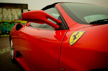 Close-up of a red luxury sports car showcasing sleek design in Den Helder, Netherlands. HD wallpaper