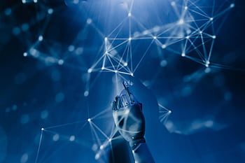 A robotic hand reaching into a digital network on a blue background, symbolizing AI technology. HD wallpaper
