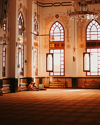 A peaceful scene inside a mosque, highlighting elegant arches and stained glass windows. HD phone wallpaper