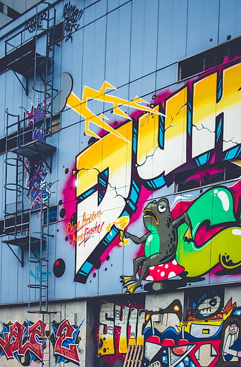 Colorful graffiti mural featuring bold text and frog on urban building wall. HD phone wallpaper