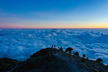Breathtaking mountain view at sunset above the clouds in Guatemala, perfect for nature enthusiasts. HD wallpaper