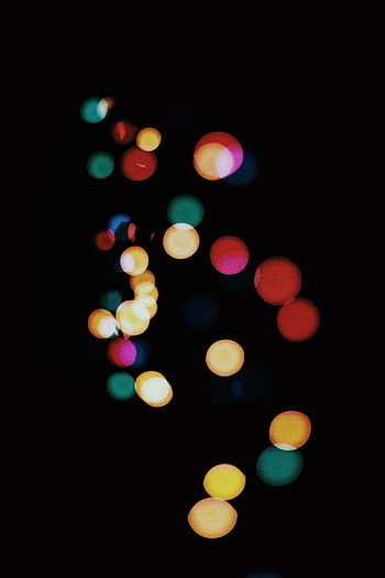 Abstract bokeh lights creating a vibrant, colorful pattern against a dark background. HD phone wallpaper