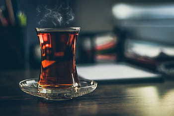 Close-up of steaming Turkish tea in a traditional glass, creating a cozy and inviting atmosphere. HD wallpaper