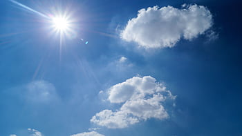 Vibrant blue sky with fluffy clouds and bright sun. Perfect cloudscape background. HD wallpaper