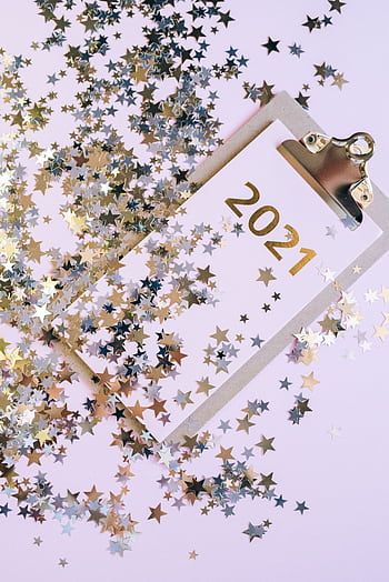 Star-shaped confetti surrounding a clipboard with '2021', celebrating the new year. HD phone wallpaper