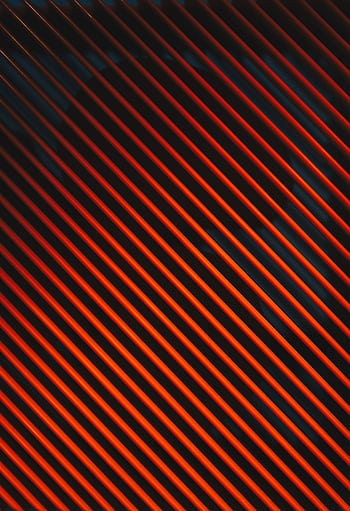 Dynamic abstract pattern of diagonal orange stripes against a dark background, providing a striking visual impact. HD phone wallpaper