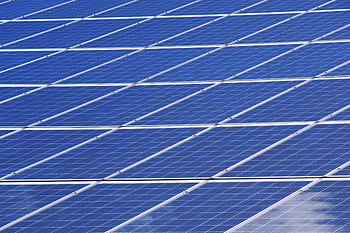 Close-up view of solar panels outdoors capturing renewable energy efficiently. HD wallpaper