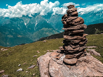 Stack of rocks with a stunning mountain landscape in the background, capturing nature's beauty and tranquility. HD wallpaper