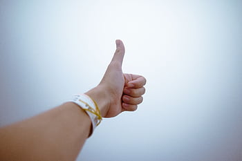 A hand giving a thumbs up gesture symbolizes approval and positivity. HD wallpaper