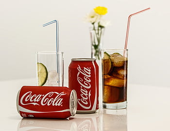 Coca-Cola cans with ice and lime on a table, fresh and invigorating. HD wallpaper