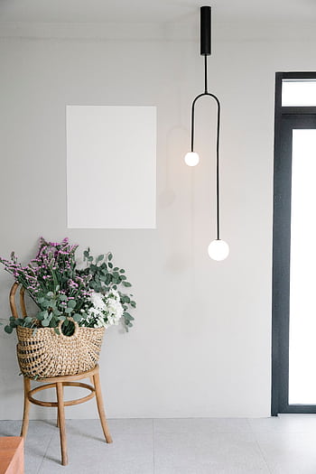 A stylish modern interior with floral arrangement and pendant lights, perfect for decor inspiration. HD phone wallpaper