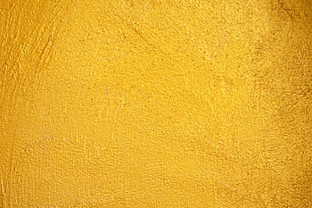 A close-up of a vibrant yellow textured wall, perfect for backgrounds and design elements. HD wallpaper