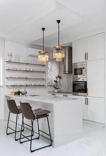 Sleek modern kitchen interior with white cabinets and elegant pendant lights. HD phone wallpaper