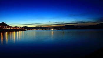 Lake Embankment Lights Mountains Under Blue Sky Reflection On Water Dark Background HD wallpaper