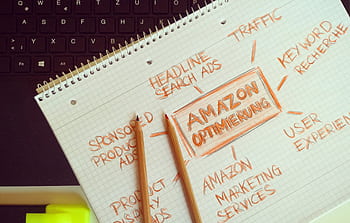 Visual representation of Amazon optimization techniques with handwritten notes and pencils. HD wallpaper
