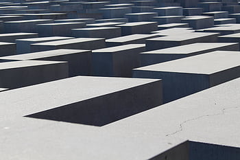 Abstract view of Berlin's Holocaust Memorial concrete blocks, evoking history and reflection. HD wallpaper
