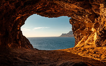 Stunning ocean view framed by a coastal cave in South Africa. HD wallpaper