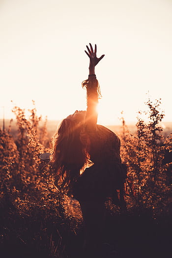 A graceful silhouette of a young woman during sunset, embodying vitality and well-being. HD phone wallpaper
