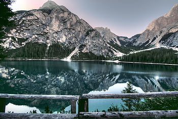 A serene mountain lake reflecting surrounding peaks, perfect for nature lovers. HD wallpaper
