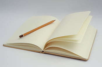 An open notebook with blank pages and a pencil, perfect for starting new ideas or journaling. HD wallpaper