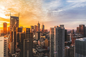 Stunning view of Melbourne's skyline at sunset, capturing modern skyscrapers and warm sky. HD wallpaper