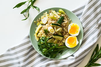 Delicious rice meal with zucchini, greens, and soft-boiled egg, perfect for a healthy diet. HD wallpaper