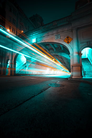 Long exposure capturing light trails in the Stockton Tunnel, San Francisco, creating a dynamic urban scene. HD phone wallpaper
