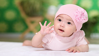 Cute Baby Girl Child Is Lying Down On Floor Wearing Light Pink Dress And Cap In Blur Background Cute HD wallpaper