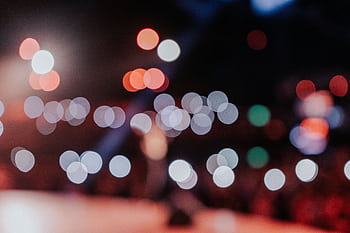 Abstract bokeh lights creating a vibrant festival atmosphere at night. HD wallpaper