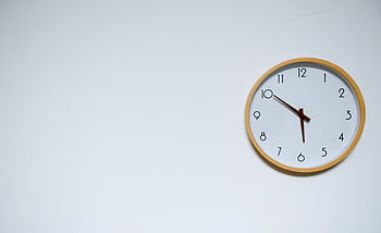 Simple wall clock with wooden frame against a white background, showing the time 10:10. HD wallpaper