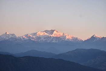 Breathtaking sunrise over the majestic snow-covered Himalayan peaks, offering serene natural beauty. HD wallpaper
