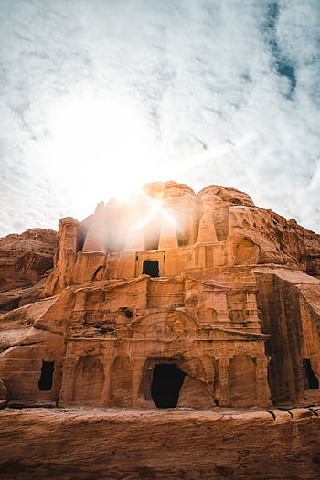 A breathtaking shot of Petra's ancient rock-cut architecture basking in sunlight, highlighting its historical grandeur. HD phone wallpaper