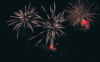 Vibrant fireworks illuminating the night sky with colorful bursts. HD wallpaper