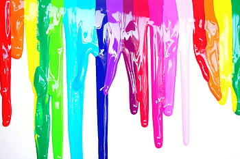 Bright, colorful paints dripping creating a rainbow effect on a white background, symbolizing diversity and creativity. HD wallpaper