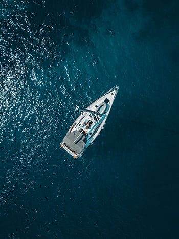 A stunning aerial shot of a sailboat cruising the deep blue waters of Croatia. HD phone wallpaper