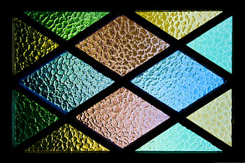 Vibrant stained glass featuring textured geometric patterns and colorful hues. HD wallpaper