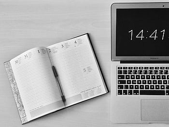 Minimalist office workspace with a notebook and MacBook Air showing 14:41 time. HD wallpaper