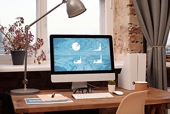 Clean and modern home office setup with computer, lamp, and decor. Ideal for productivity in a contemporary workspace. HD wallpaper