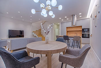 Stylish open-plan living room and kitchen with modern furnishings and lighting. HD wallpaper