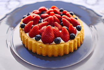 Scrumptious homemade fruit tart topped with fresh strawberries and blueberries. HD wallpaper